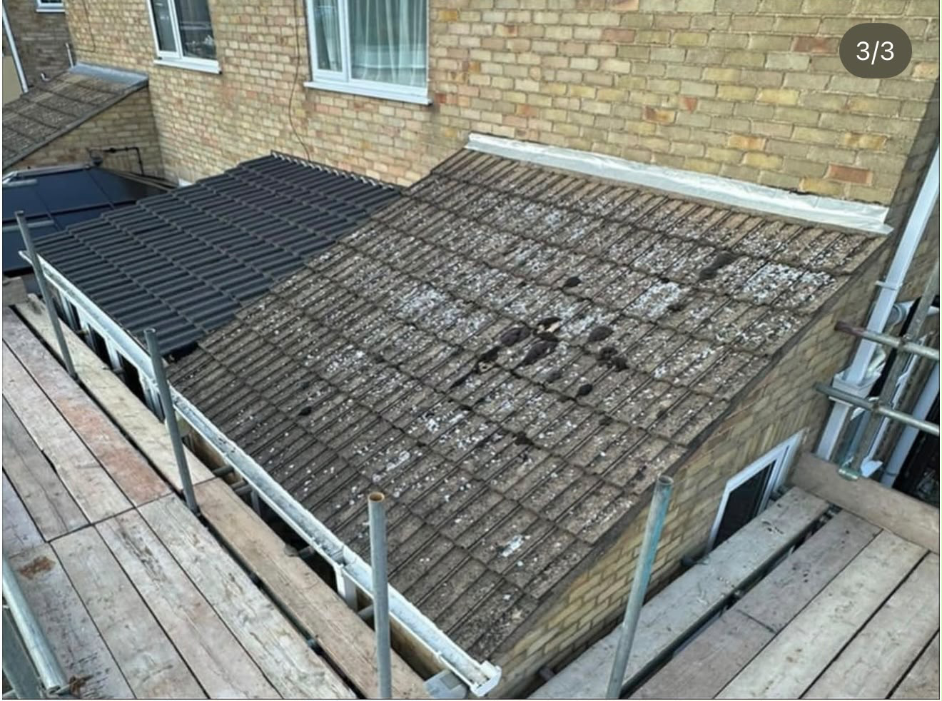 Old mossy concrete tiled roof before replacement